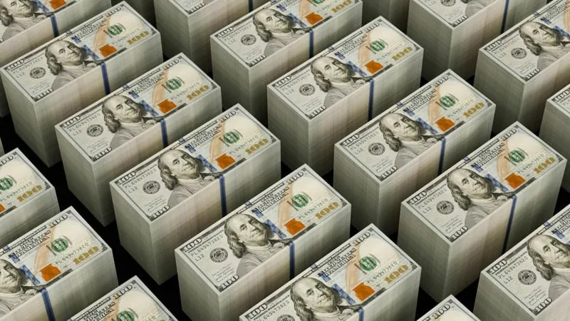 Rows of banded $100 bill stacks on a black background